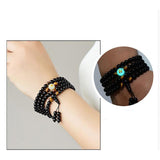 Superbe bracelet Dragon Noir, Perles naturelles, œils de tigre, et en son centre la pierre lumineuse du dragon.
